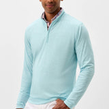 Man wearing a light blue long-sleeve shirt with a collar on a white background