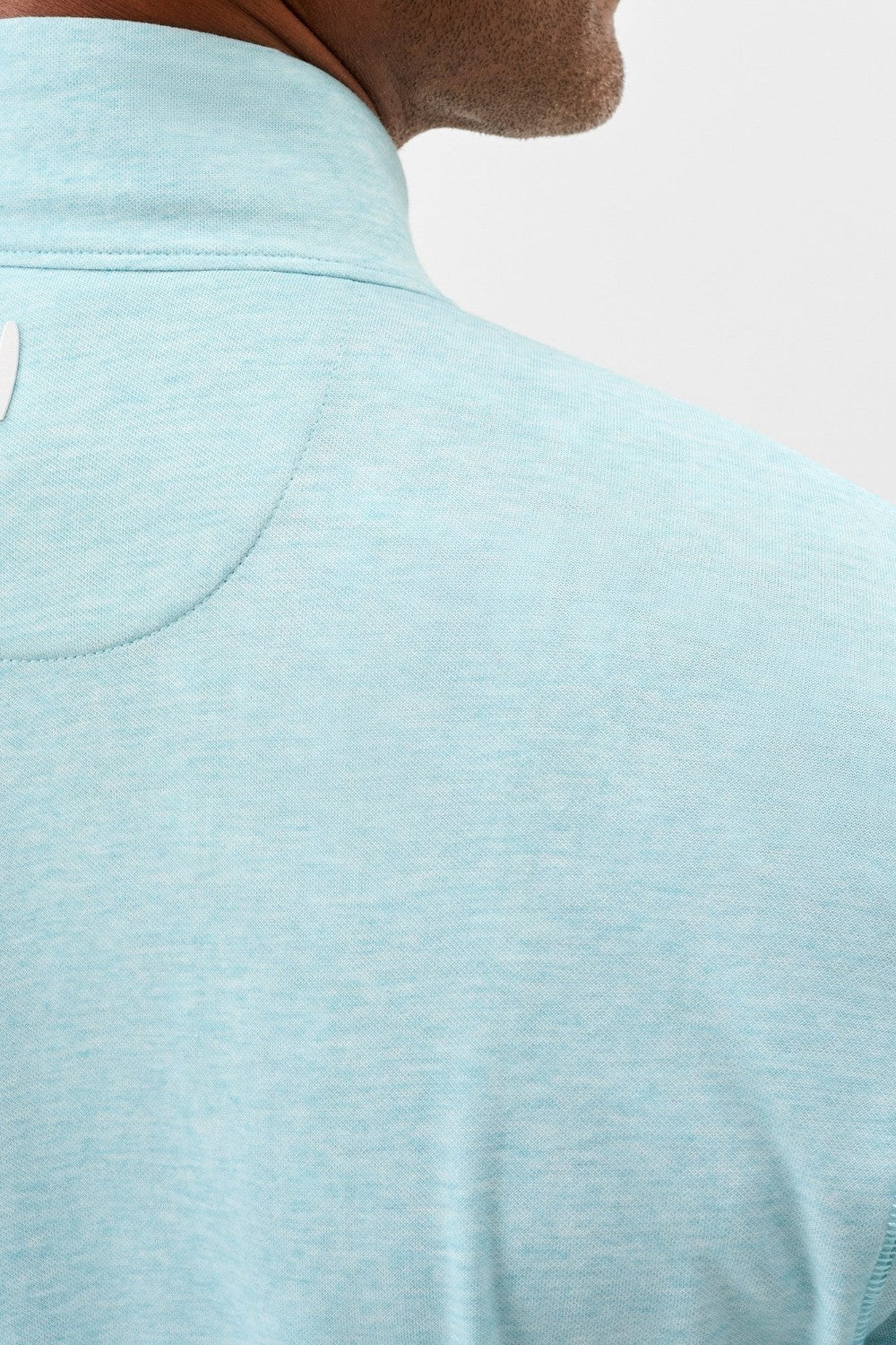 Light blue polo shirt worn by a person with a neutral background