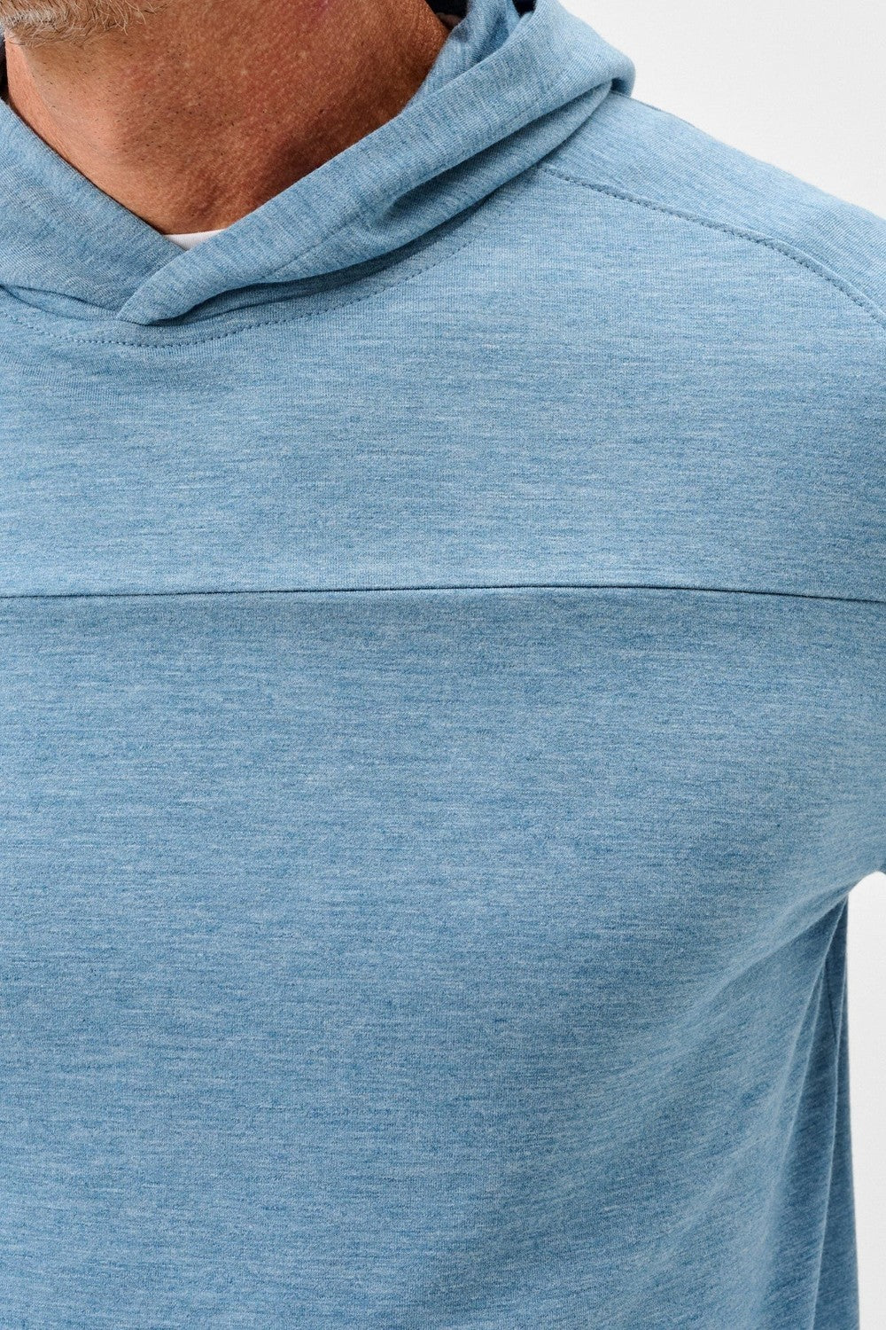 Close-up of a person wearing a blue hoodie on a white background