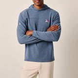 Man wearing a blue hoodie with a logo on a beige background