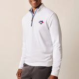 Man wearing a white quarter-zip pullover with a logo on a beige background
