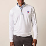 Man wearing a white quarter-zip pullover with a logo on a beige background