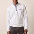 Man wearing a white quarter-zip pullover with a logo on a beige background