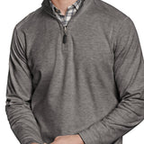 Man wearing a gray pullover with a plaid shirt underneath on a white background