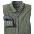 Folded green cardigan with a blue shirt inside on a white background