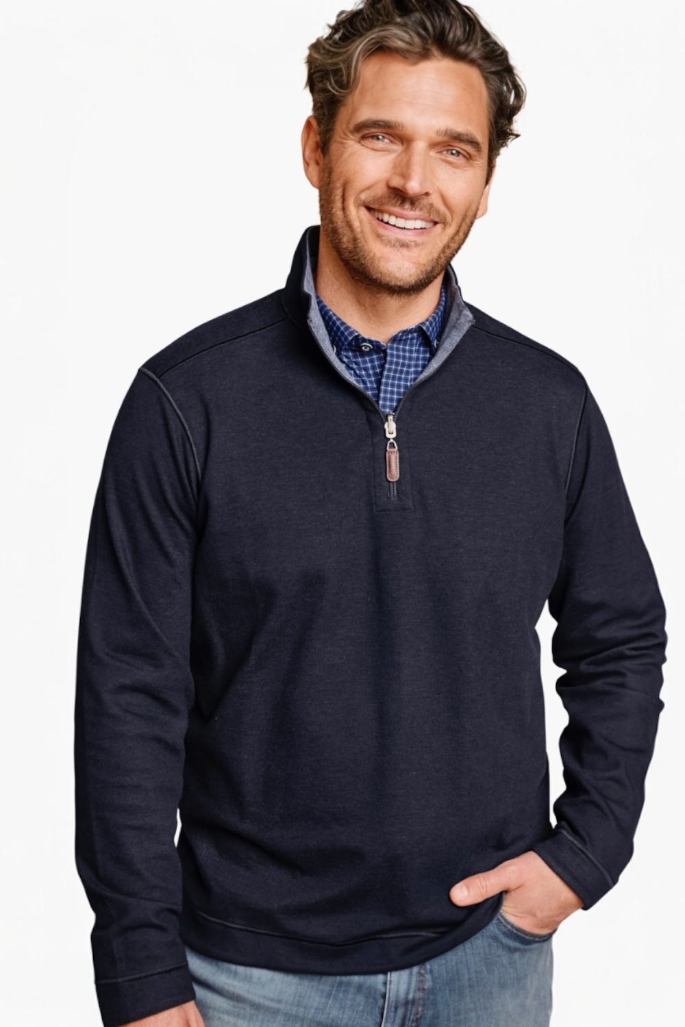 Man wearing a navy blue quarter-zip sweatshirt over a checkered shirt on a white background