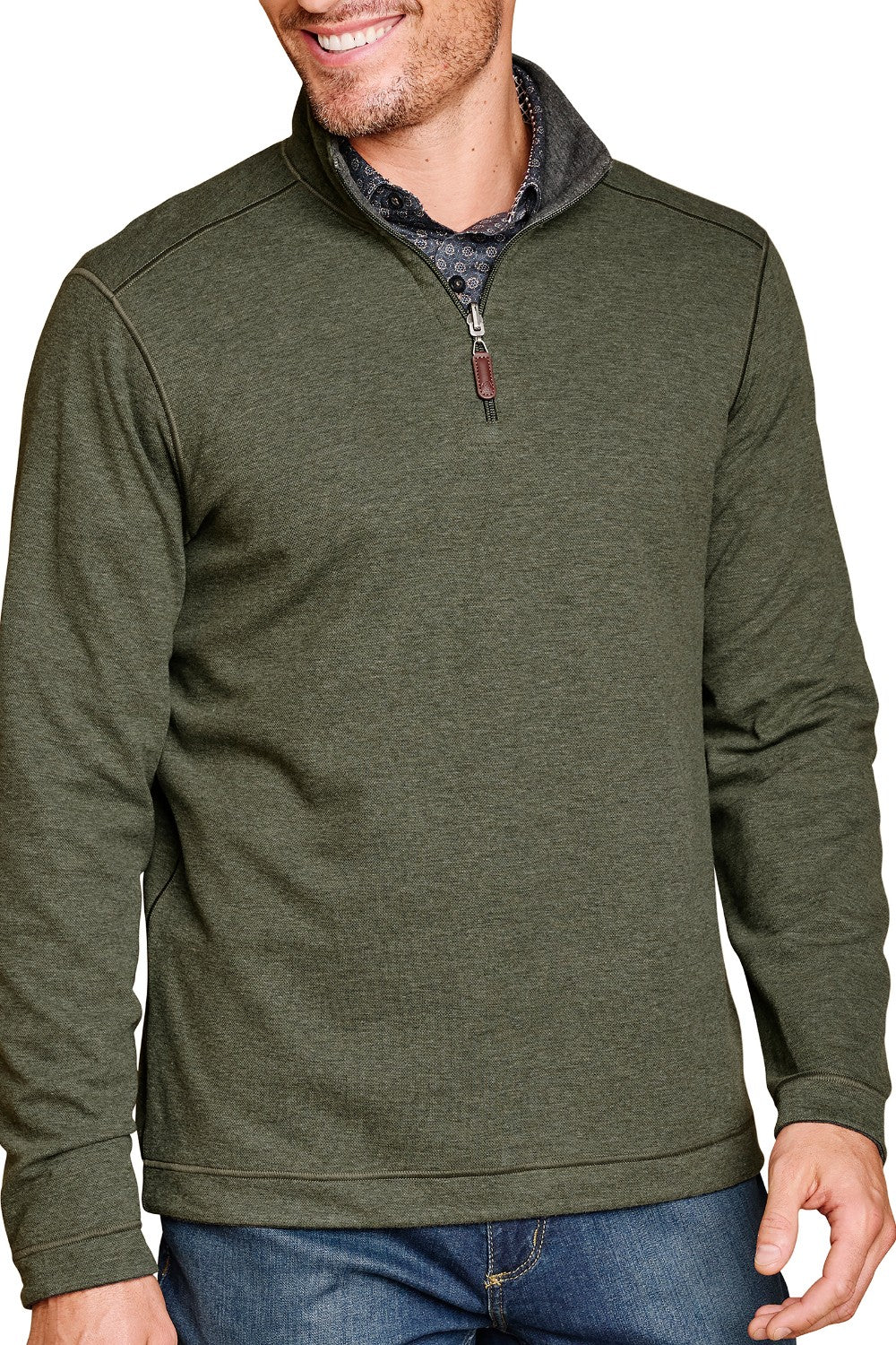Man wearing a green pullover with a zipper, standing against a white background