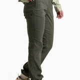 Person wearing olive green pants and a light green jacket on a white background
