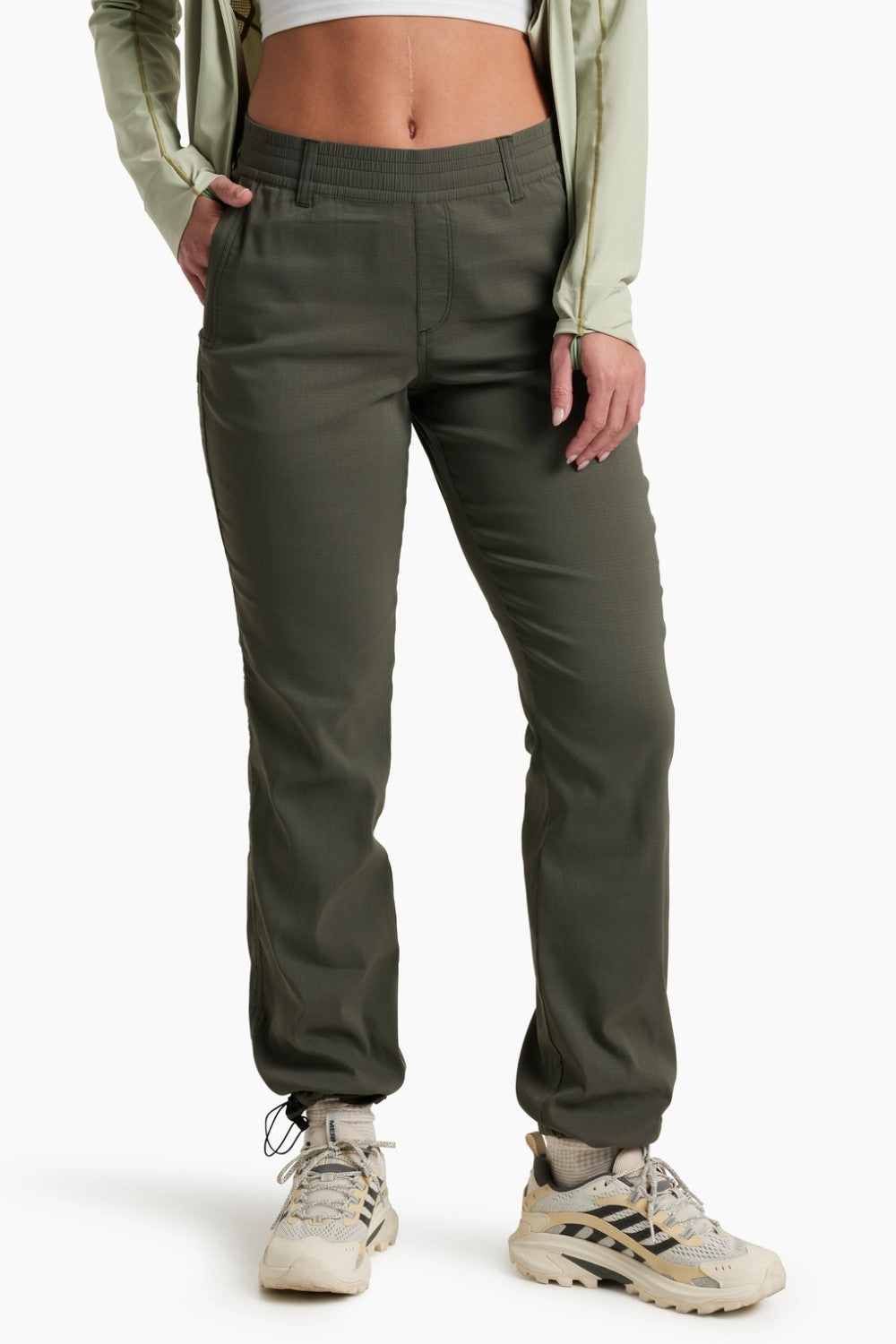 Person wearing olive green pants on a white background