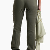 Person wearing green cargo pants with a white background