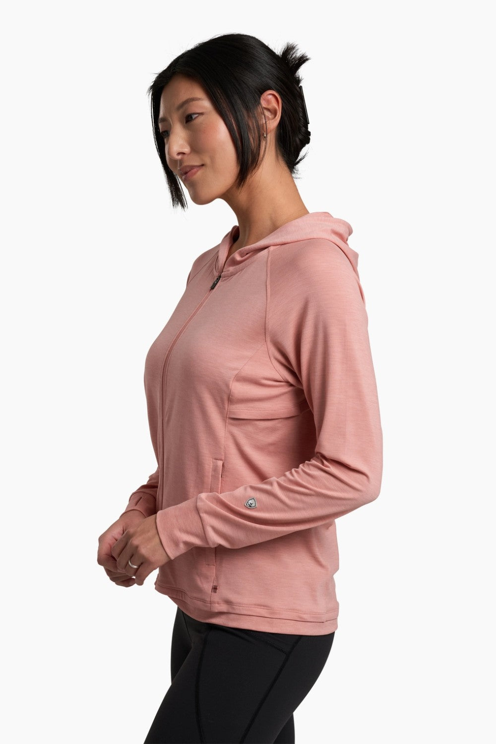 Woman wearing a pink hoodie on a white background
