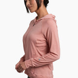 Woman wearing a pink hoodie on a white background