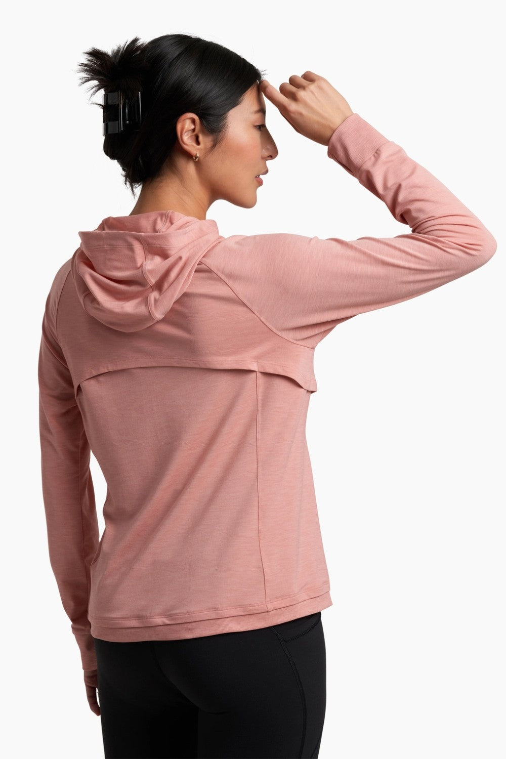 Woman wearing a pink hoodie on a white background