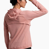 Woman wearing a pink hoodie on a white background