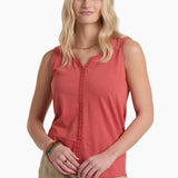 Woman wearing a red sleeveless top and beige pants on a white background