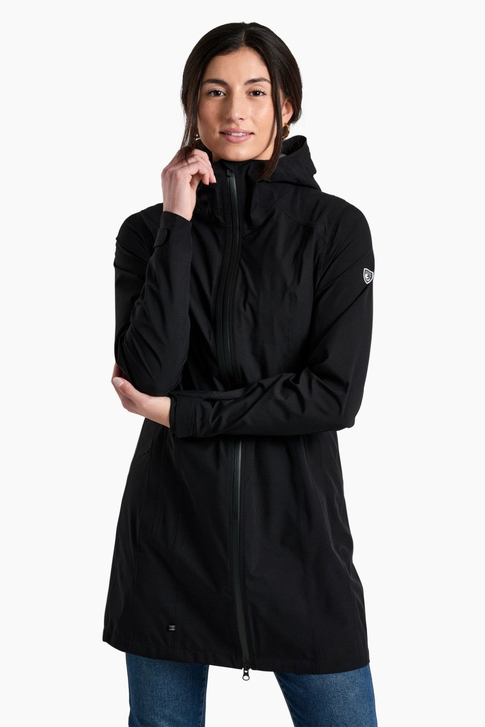 Person wearing a black hooded jacket on a white background