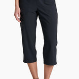 Person wearing black capri pants on a white background