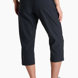 Person wearing black capri pants on a white background