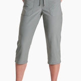 Person wearing gray capri pants on a white background