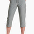 Person wearing gray capri pants on a white background