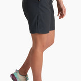 Person wearing black shorts and colorful shoes on a white background