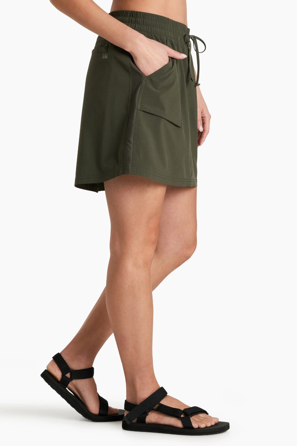 Person wearing green skort on a white background