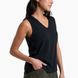 Woman wearing a black sleeveless top and green shorts on a white background