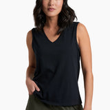 Woman wearing a black sleeveless top and green shorts on a white background