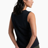 Woman wearing a black sleeveless top and green shorts on a white background