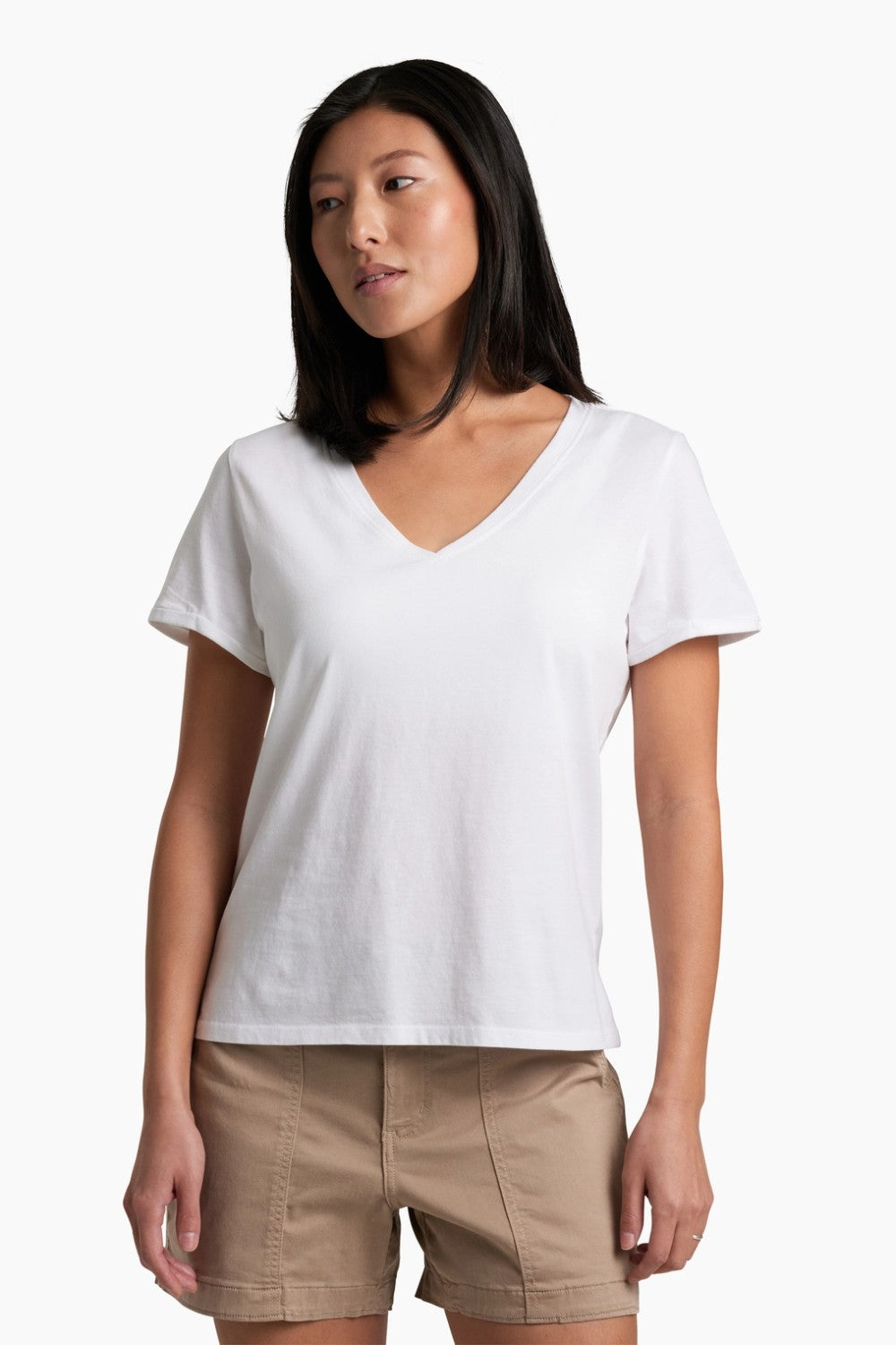 Woman wearing a white t-shirt and beige shorts on a white background