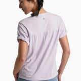 Person wearing a soft purple top with blue jeans on a white background