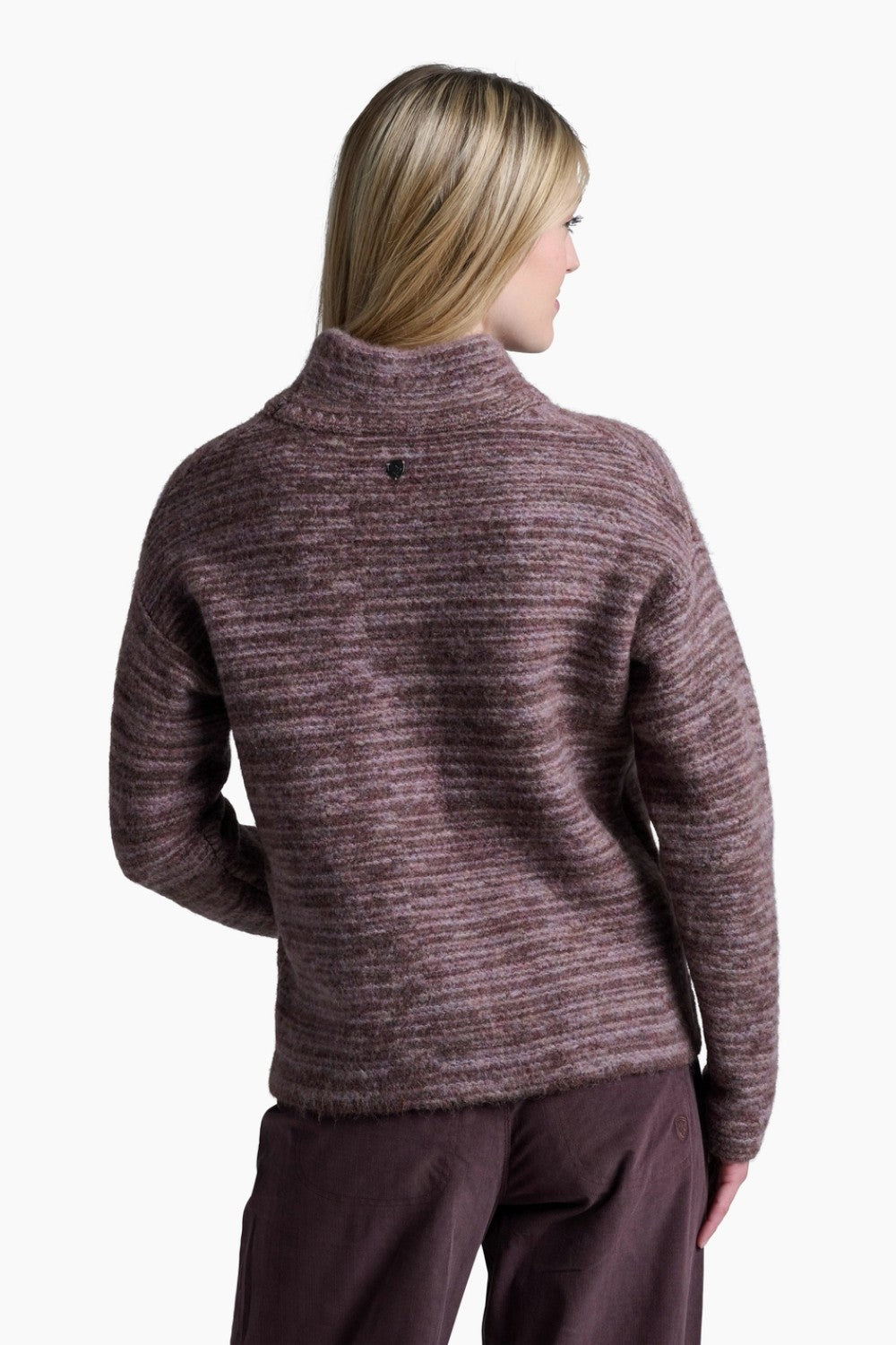 Woman wearing a maroon sweater and pants on a white background