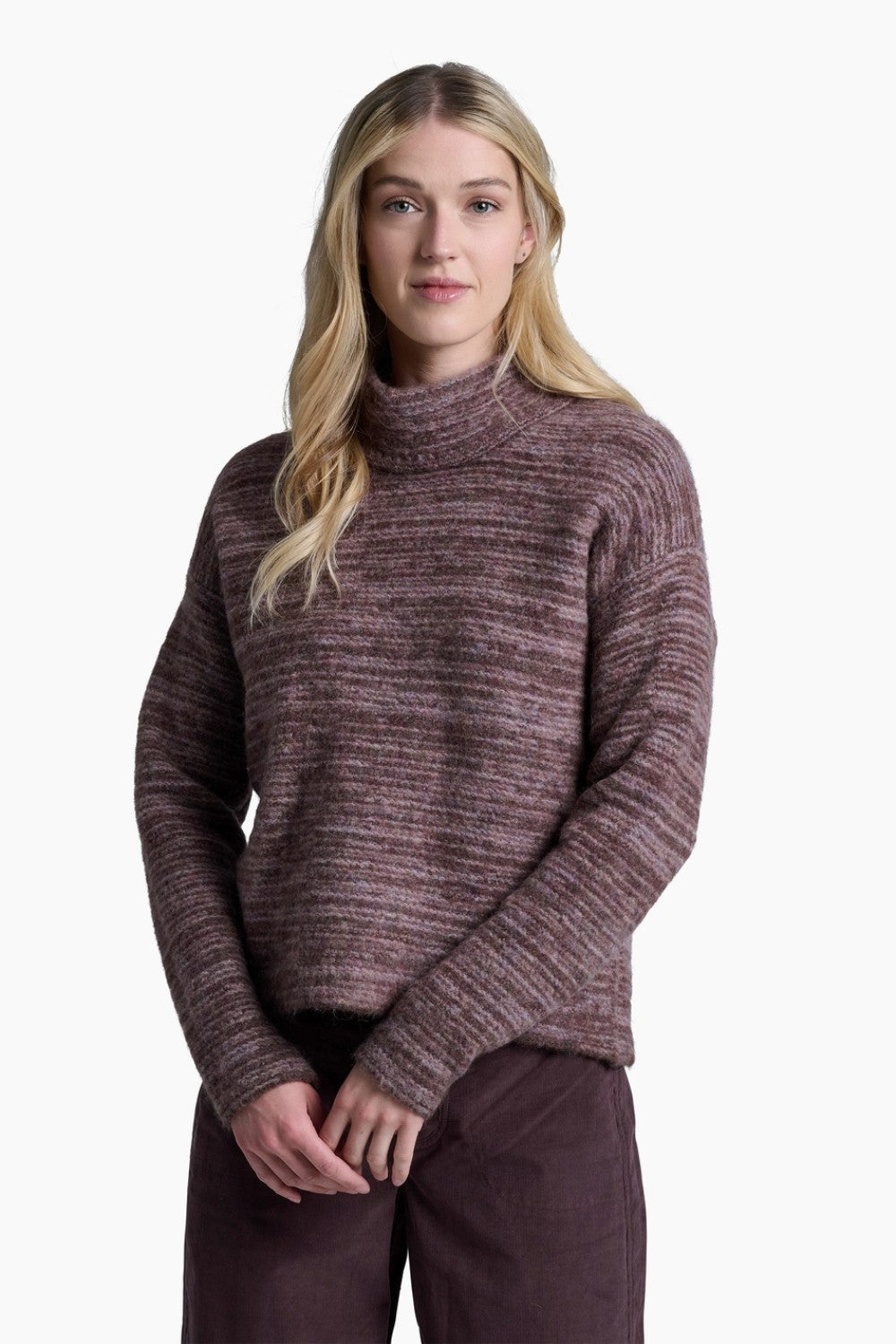 Woman wearing a maroon sweater and pants on a white background