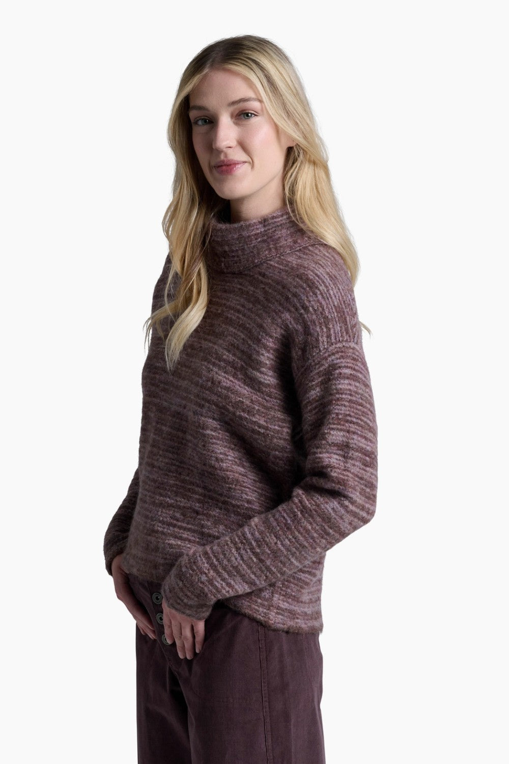 Woman wearing a brown sweater and pants on a white background