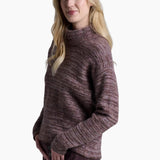 Woman wearing a brown sweater and pants on a white background