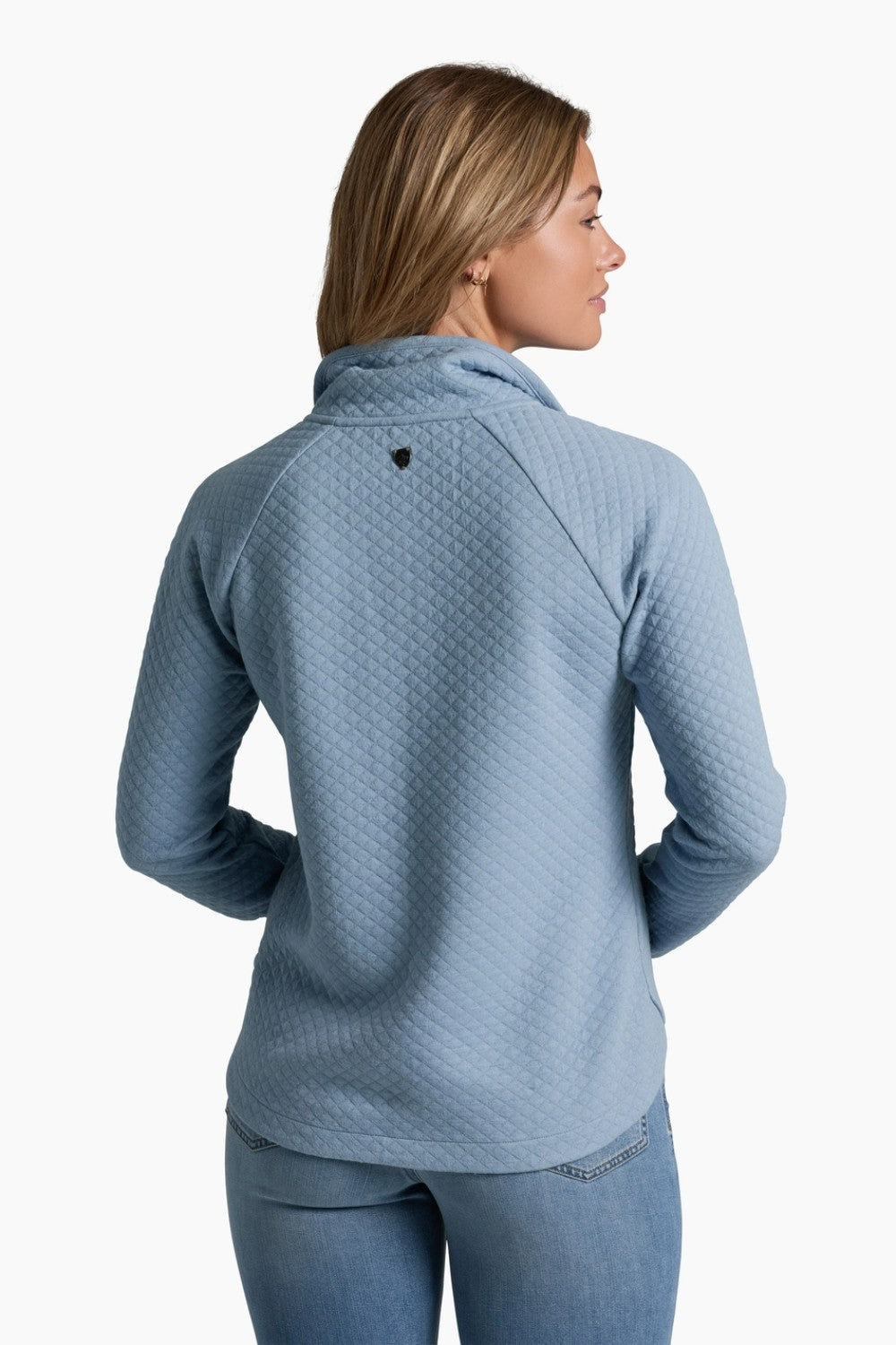 Woman wearing a blue textured sweater on a white background