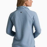 Woman wearing a blue textured sweater on a white background