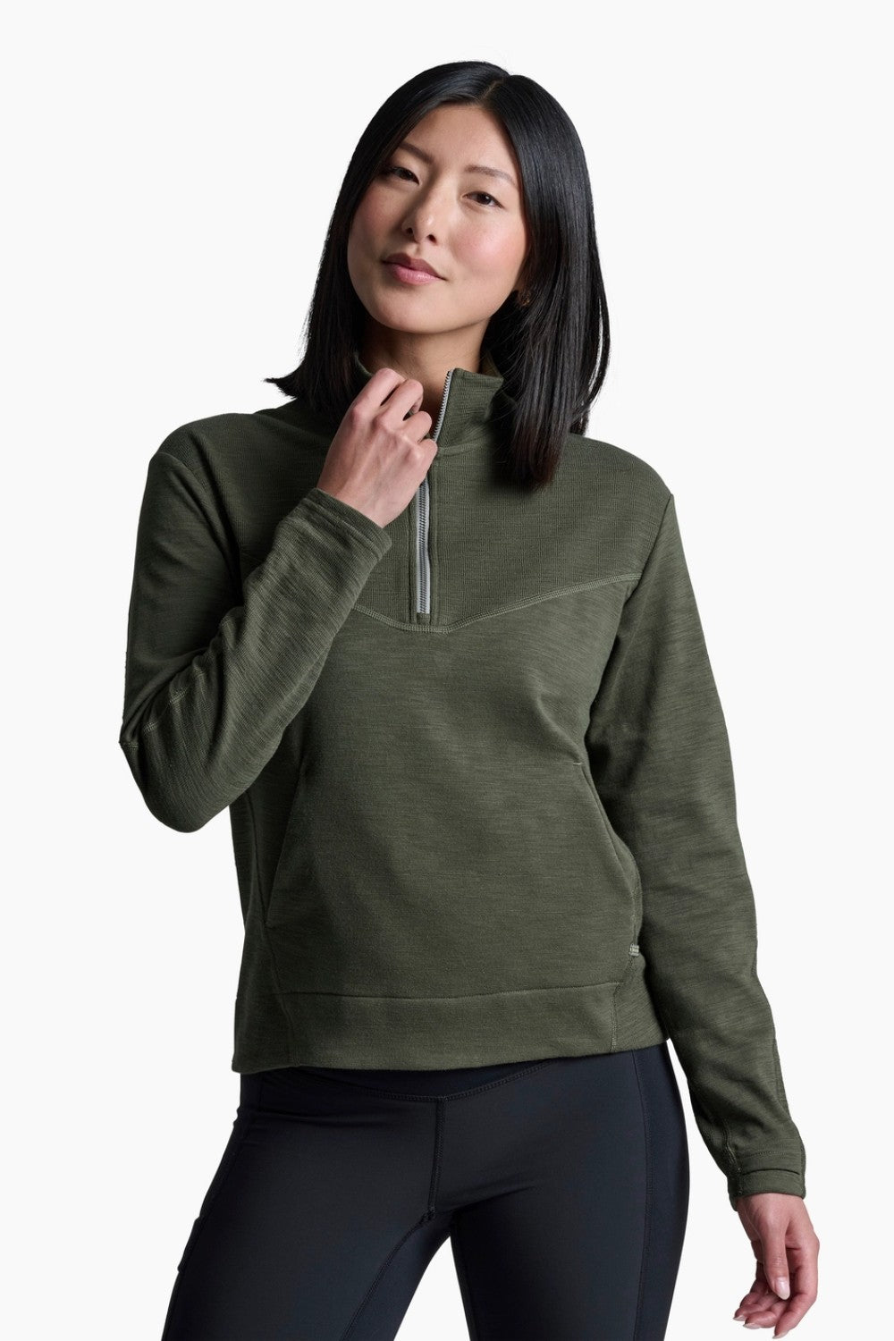 Woman wearing a green pullover with a zipper on a white background