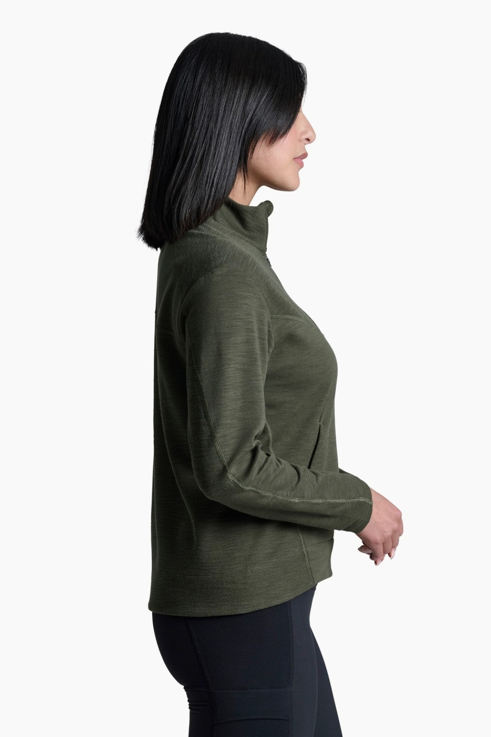 Woman wearing a green long-sleeve top on a white background
