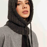 Women wearing charcoal hooded scarf with grey jacket, black T  on light background