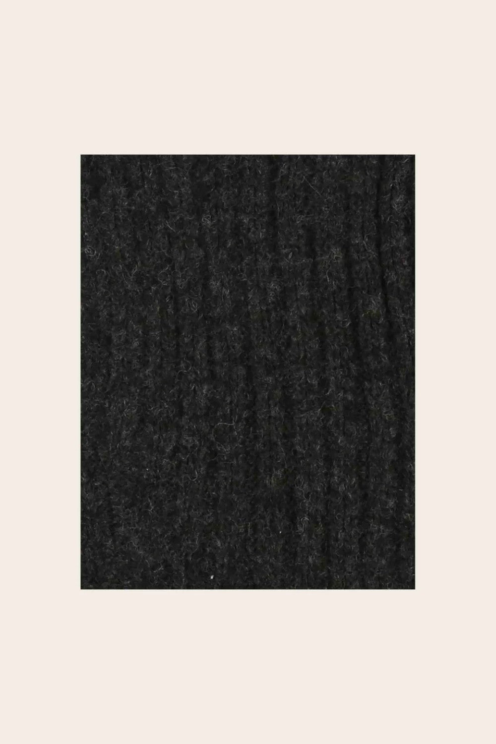 Closeup of charcoal knitted fabric on light background