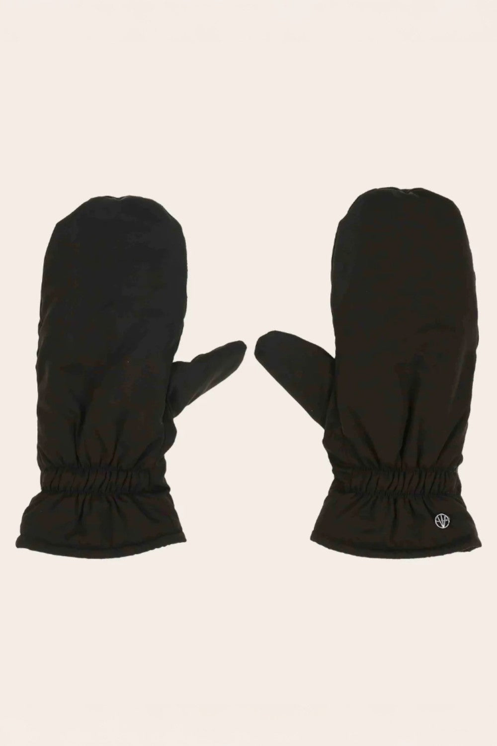 Pair of black mittens on a beige background