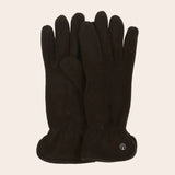 Pair of black gloves on a beige background