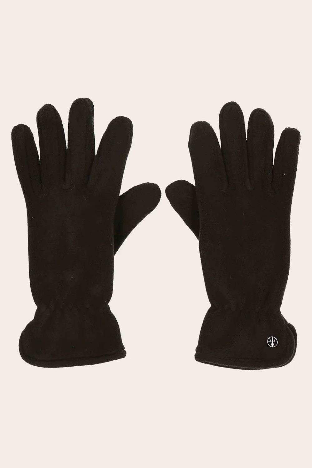 Pair of black gloves on a beige background