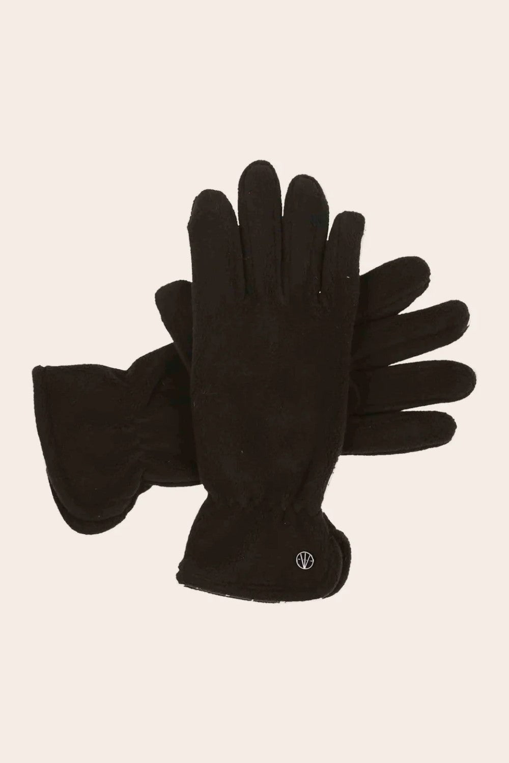 Pair of black gloves on a beige background