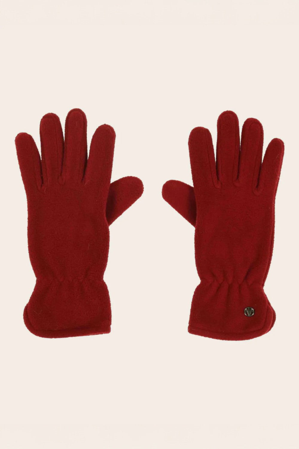 Pair of red gloves on a beige background