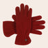 Red gloves with a brand logo on a beige background