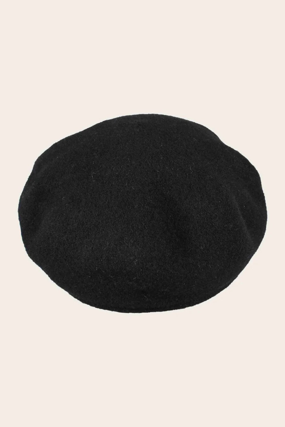 Black cap on a beige background