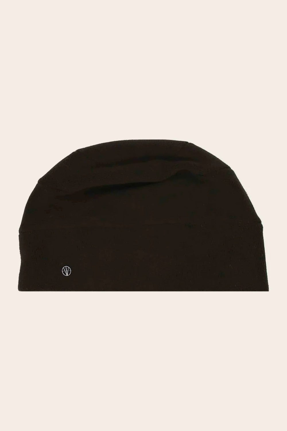 Black beanie hat on a beige background