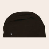 Black beanie hat on a beige background
